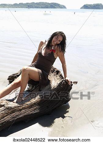 "Woman, 45 years, posing in a beach dress on a tree stump, Playa Samara, Nicoya Peninsula, Costa Rica, Central America, North America" View Large Photo Image Stock Image - "Woman, 45 years, posing in a beach dress on a tree stump, Playa Samara, Nicoya Peninsula, Costa Rica, Central America, North America". Fotosearch