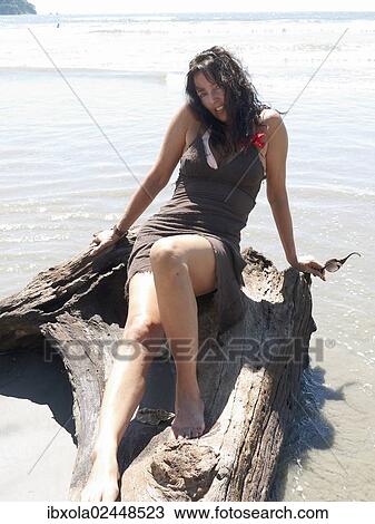 "Woman, 45 years, posing in a beach dress on a tree stump, Playa Samara, Nicoya Peninsula, Costa Rica, Central America, North America" View Large Photo Image Stock Image - "Woman, 45 years, posing in a beach dress on a tree stump, Playa Samara, Nicoya Peninsula, Costa Rica, Central America, North America". Fotosearch