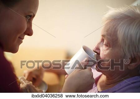 Stock Photo - "Woman, 85 years, in a nursing home, at breakfast, supported by a geriatric nurse, Kralovske Porici, Bohemia, Czech Republic, Europe". Fotosearch