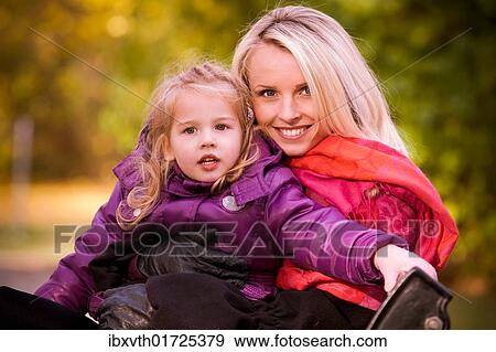 Woman and girl in the park in autumn View Large Photo Image Stock Photo - Woman and girl in the park in autumn. Fotosearch