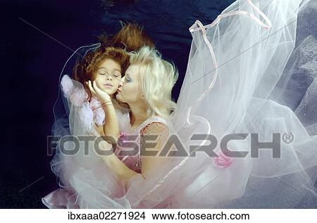 "Woman and girl presenting underwater fashion in pool, Odessa, Ukraine, Eastern Europe, Europe" View Large Photo Image Picture - "Woman and girl presenting underwater fashion in pool, Odessa, Ukraine, Eastern Europe, Europe". Fotosearch