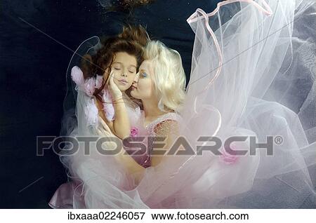 "Woman and girl, underwater models, presenting fashion in pool, Odessa, Ukraine, Eastern Europe, Europe" View Large Photo Image Stock Photo - "Woman and girl, underwater models, presenting fashion in pool, Odessa, Ukraine, Eastern Europe, Europe". Fotosearch