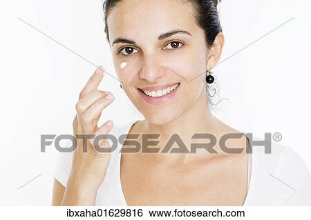 Woman applying skin cream View Large Photo Image Stock Photograph - Woman applying skin cream. Fotosearch
