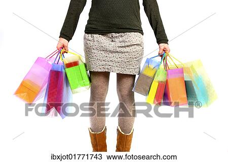 Stock Image - Woman carrying bags full of gifts. Fotosearch