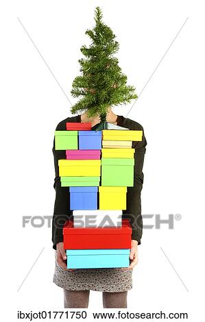 Woman carrying cardboard boxes with gifts and a small Christmas tree View Large Photo Image Stock Image - Woman carrying cardboard boxes with gifts and a small Christmas tree. Fotosearch