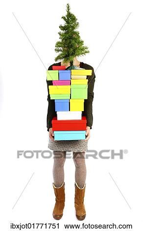 Woman carrying cardboard boxes with gifts and a small Christmas tree View Large Photo Image Stock Image - Woman carrying cardboard boxes with gifts and a small Christmas tree. Fotosearch