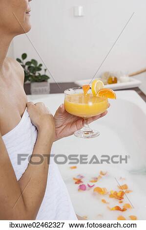 Woman drinking a cocktail in the bathtub View Large Photo Image Stock Photo - Woman drinking a cocktail in the bathtub. Fotosearch