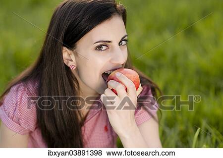 Stock Photo - Woman eating an apple. Fotosearch