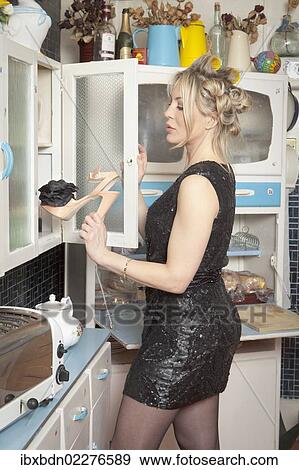 Woman holding a high heeled shoe View Large Photo Image Stock Photo - Woman holding a high heeled shoe. Fotosearch