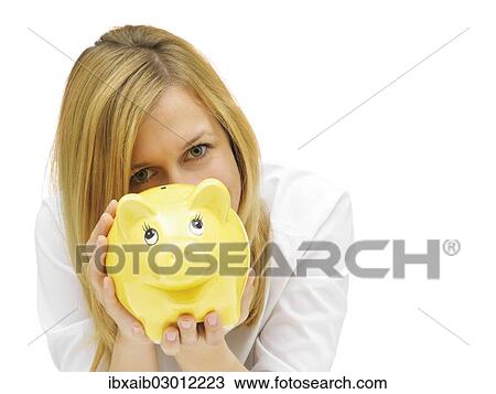 Stock Image - Woman holding a piggy bank. Fotosearch
