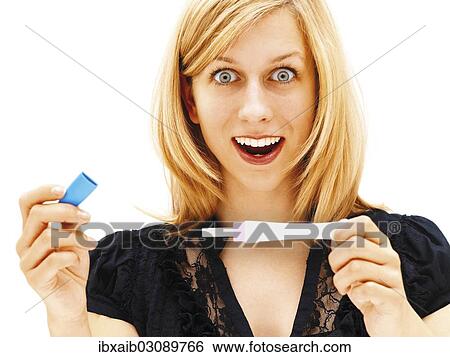"Woman holding a pregnancy test, happy" View Large Photo Image Stock Photograph - "Woman holding a pregnancy test, happy". Fotosearch