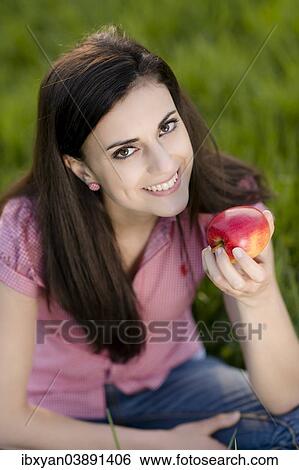 Stock Photograph - Woman holding an apple. Fotosearch