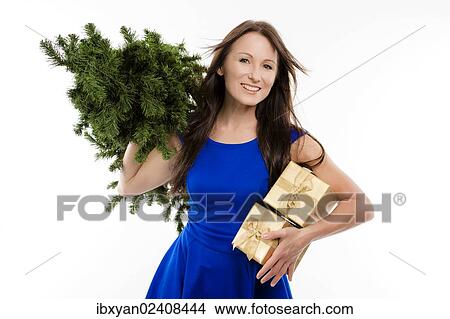 Woman holding an empty Christmas tree and gifts View Large Photo Image Picture - Woman holding an empty Christmas tree and gifts. Fotosearch