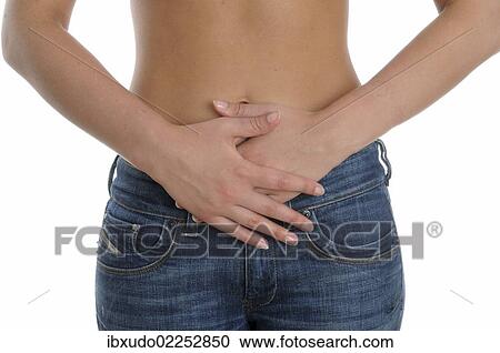Stock Image - Woman holding both hands over her belly. Fotosearch