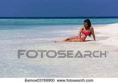 "Woman in a pink bikini lying on the beach, Male, North Male Atoll, Maldives, Asia" View Large Photo Image Stock Image - "Woman in a pink bikini lying on the beach, Male, North Male Atoll, Maldives, Asia". Fotosearch