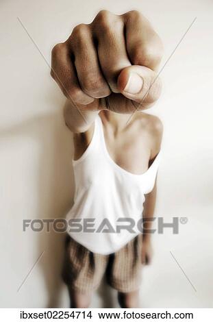 "Woman in a vest and underpants holding her fist in front of her face, woman fighting against violence" View Large Photo Image Picture - "Woman in a vest and underpants holding her fist in front of her face, woman fighting against violence". Fotosearch