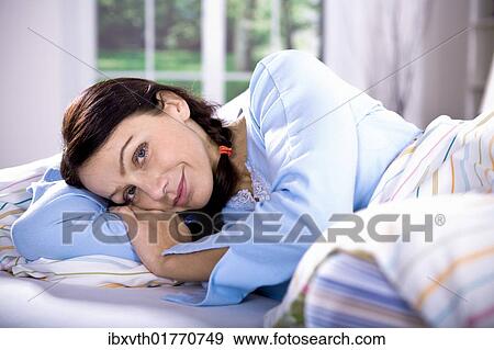 Woman in bed View Large Photo Image Stock Photo - Woman in bed. Fotosearch