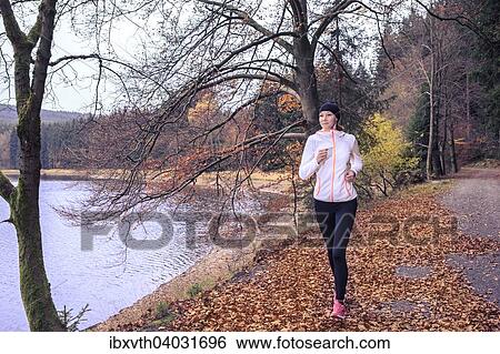 "Woman jogging along a lake, Scheibe-Alsbach, Thuringia, Germany, Europe" View Large Photo Image Stock Photograph - "Woman jogging along a lake, Scheibe-Alsbach, Thuringia, Germany, Europe". Fotosearch