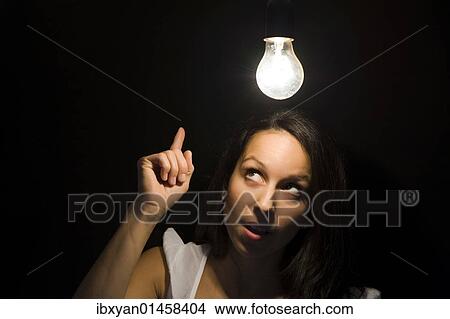 "Woman, light bulb, symbolic image for enlightenment" View Large Photo Image Picture - "Woman, light bulb, symbolic image for enlightenment". Fotosearch