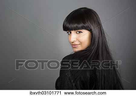 Stock Image - "Woman looking over her shoulder, Germany, Europe". Fotosearch