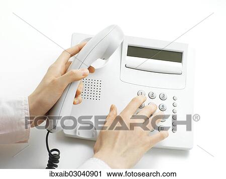 Woman making a call on a telephone View Large Photo Image Stock Image - Woman making a call on a telephone. Fotosearch