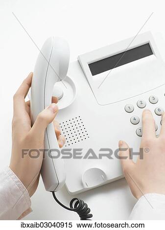 Woman making a call on a telephone View Large Photo Image Stock Photography - Woman making a call on a telephone. Fotosearch