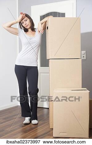 Woman moving house View Large Photo Image Stock Photo - Woman moving house. Fotosearch