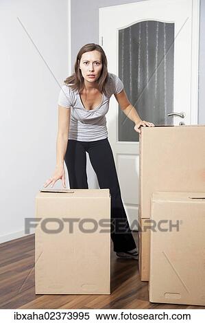 Woman moving house View Large Photo Image Stock Photography - Woman moving house. Fotosearch