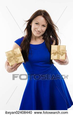 Woman oldwearing a blue dress holding presents View Large Photo Image Stock Image - Woman oldwearing a blue dress holding presents. Fotosearch