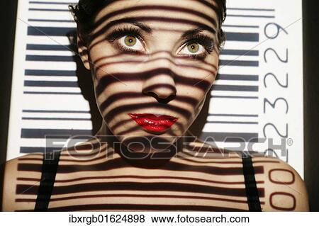 Stock Photo - Woman portrait with projected bar code as a symbolic image for biometrics. Fotosearch