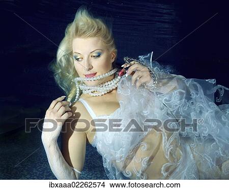 Woman presenting underwater fashion in a pool View Large Photo Image Picture - Woman presenting underwater fashion in a pool. Fotosearch