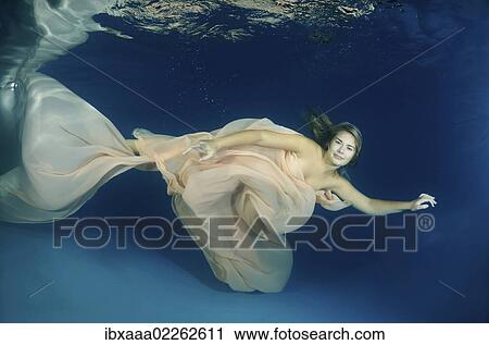 Woman presenting underwater fashion in a pool View Large Photo Image Stock Image - Woman presenting underwater fashion in a pool. Fotosearch