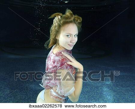 Woman presenting underwater fashion in a pool View Large Photo Image Stock Photo - Woman presenting underwater fashion in a pool. Fotosearch