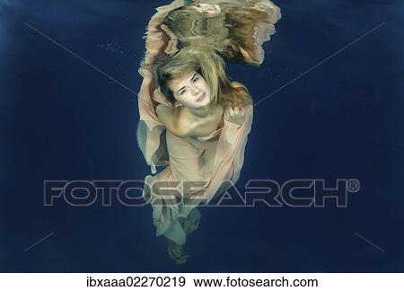 Woman presenting underwater fashion in a pool View Large Photo Image Stock Photo - Woman presenting underwater fashion in a pool. Fotosearch