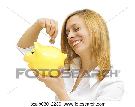 Woman putting a coin into a piggy bank View Large Photo Image Stock Image - Woman putting a coin into a piggy bank. Fotosearch