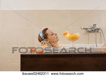 Woman relaxing in a bath View Large Photo Image Stock Image - Woman relaxing in a bath. Fotosearch