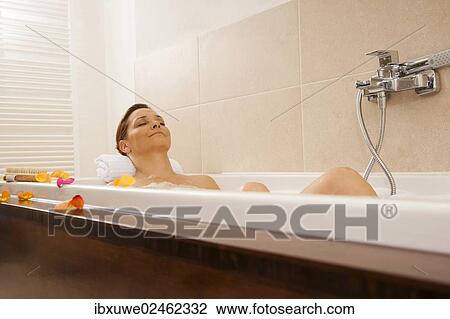 Woman relaxing in a bath View Large Photo Image Stock Image - Woman relaxing in a bath. Fotosearch