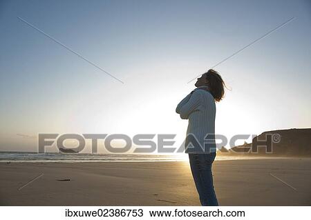 Woman relaxing on the beach at night View Large Photo Image Stock Image - Woman relaxing on the beach at night. Fotosearch