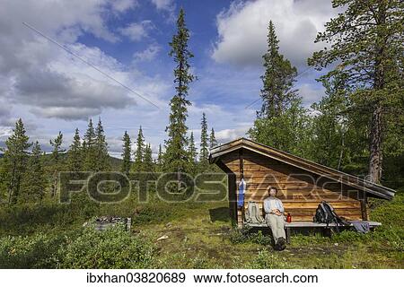 "Woman resting at a wind shelter and campsite, Norrbotten County, Sweden, Europe" View Large Photo Image Stock Photo - "Woman resting at a wind shelter and campsite, Norrbotten County, Sweden, Europe". Fotosearch