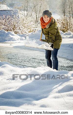 Woman shovelling snow View Large Photo Image Picture - Woman shovelling snow. Fotosearch