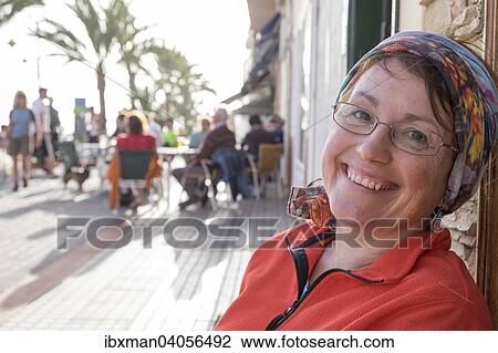 Stock Image - "Woman sitting on a beach promenade, La Playa, Valle Gran Rey, La Gomera, Canary Islands, Spain, Europe". Fotosearch