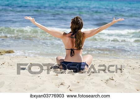 "Woman sitting on the beach, Ibiza, Spain, Europe" View Large Photo Image Stock Image - "Woman sitting on the beach, Ibiza, Spain, Europe". Fotosearch