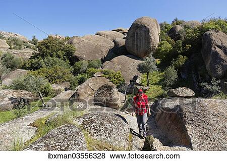 "Woman wearing a backpack while hiking in the Latmos Mountains, Lake Bafa, Besparmak Mountains, Mugla Province, Aegean region, Turkey, Asia" View Large Photo Image Stock Photo - "Woman wearing a backpack while hiking in the Latmos Mountains, Lake Bafa, Besparmak Mountains, Mugla Province, Aegean region, Turkey, Asia". Fotosearch