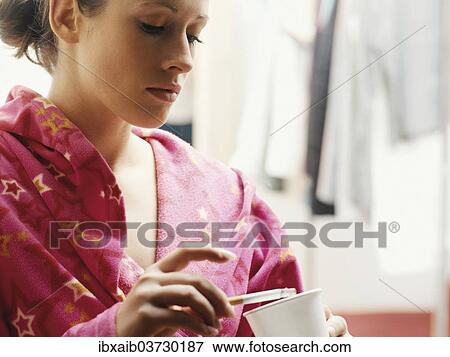 Woman wearing a bathrobe smoking a cigarette View Large Photo Image Stock Photo - Woman wearing a bathrobe smoking a cigarette. Fotosearch