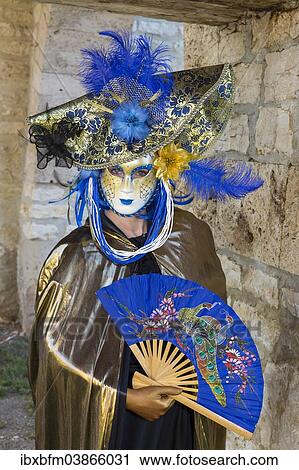 Woman wearing a Venetian mask and a costume View Large Photo Image Stock Image - Woman wearing a Venetian mask and a costume. Fotosearch