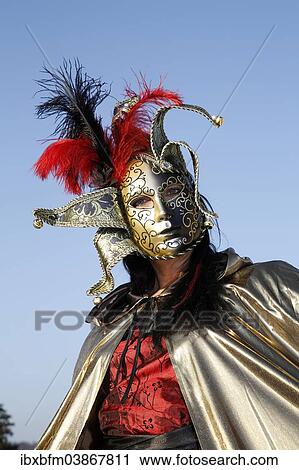 Woman wearing a Venetian mask and a costume View Large Photo Image Stock Image - Woman wearing a Venetian mask and a costume. Fotosearch