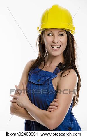 Woman wearing blue overalls and a hardhat View Large Photo Image Stock Image - Woman wearing blue overalls and a hardhat. Fotosearch