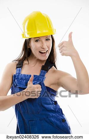 Woman wearing blue overalls and a hardhat View Large Photo Image Stock Photograph - Woman wearing blue overalls and a hardhat. Fotosearch