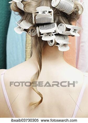 Woman wearing curlers with a single strand of hair hanging down View Large Photo Image Stock Photography - Woman wearing curlers with a single strand of hair hanging down. Fotosearch