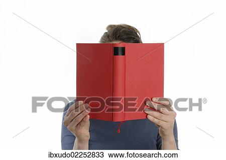 Woman with a red book in front of her face View Large Photo Image Stock Image - Woman with a red book in front of her face. Fotosearch